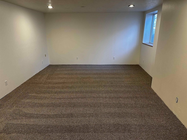 unfurnished room featuring dark colored carpet and recessed lighting