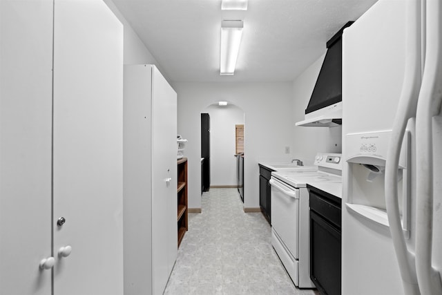 kitchen featuring white cabinetry, sink, and white appliances