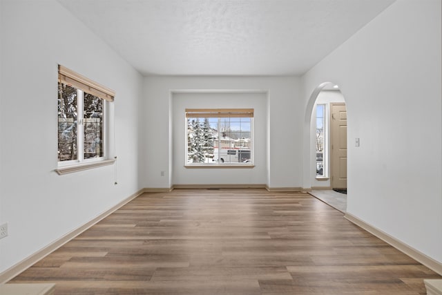 empty room with hardwood / wood-style flooring and a textured ceiling