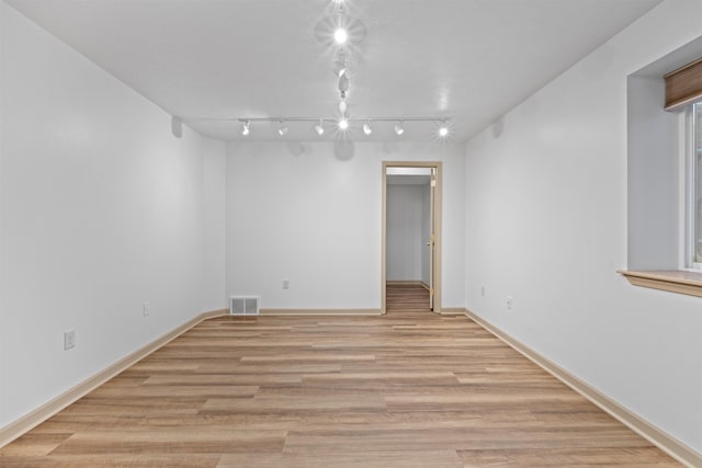 spare room featuring light wood-type flooring