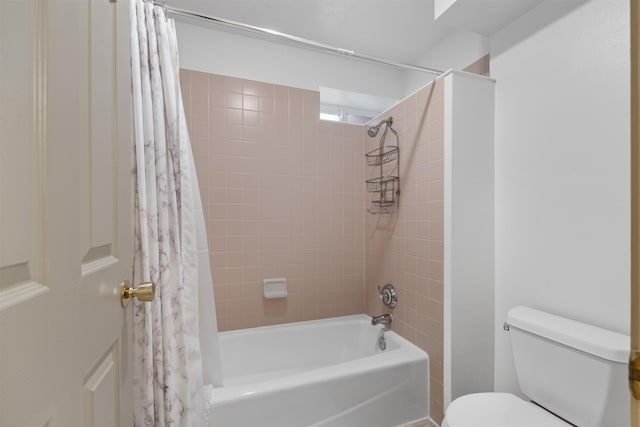 bathroom featuring shower / bathtub combination with curtain and toilet