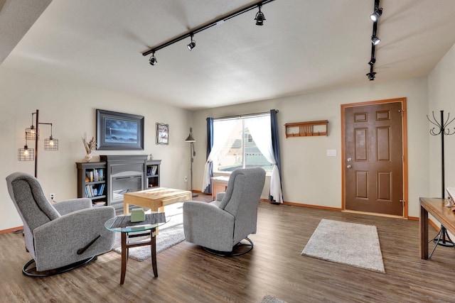 living room with baseboards and wood finished floors