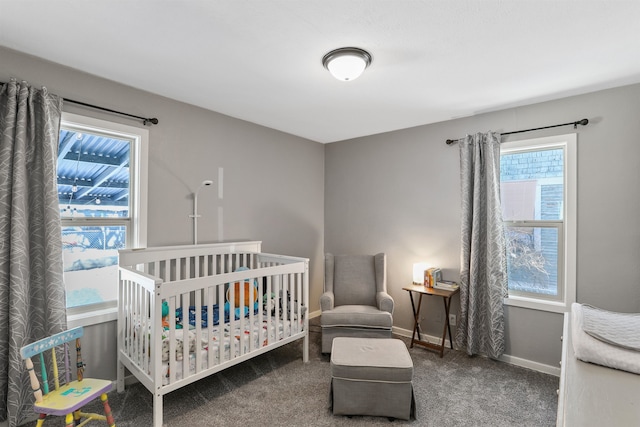 carpeted bedroom featuring a nursery area