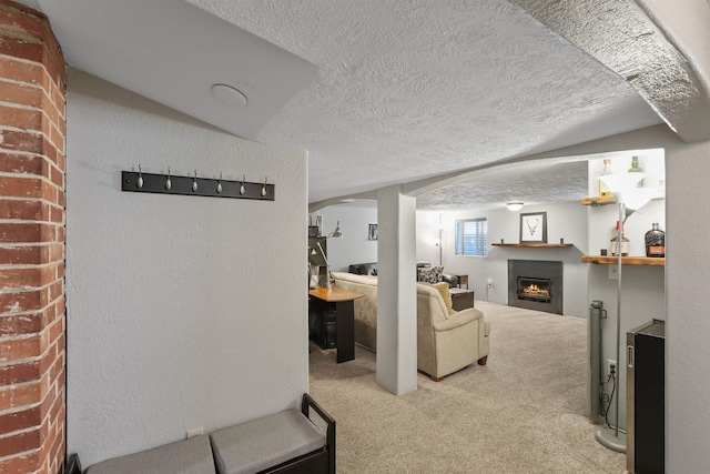 living room with carpet floors and a textured ceiling