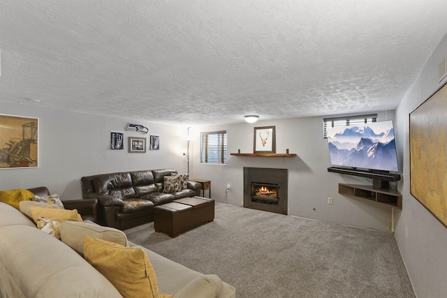 carpeted living room featuring a healthy amount of sunlight and a textured ceiling