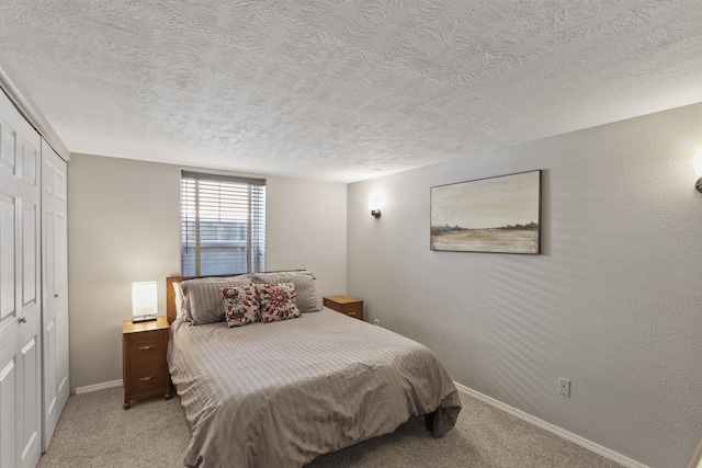 bedroom featuring carpet floors, a closet, and a textured ceiling