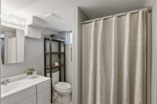 bathroom with vanity, a shower with shower curtain, a textured ceiling, and toilet