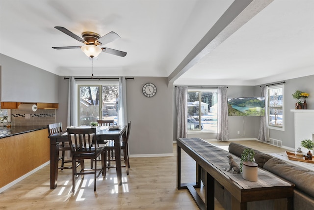 dining space featuring ceiling fan and light wood-type flooring