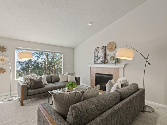 living room with a tiled fireplace, lofted ceiling, light carpet, and a textured ceiling