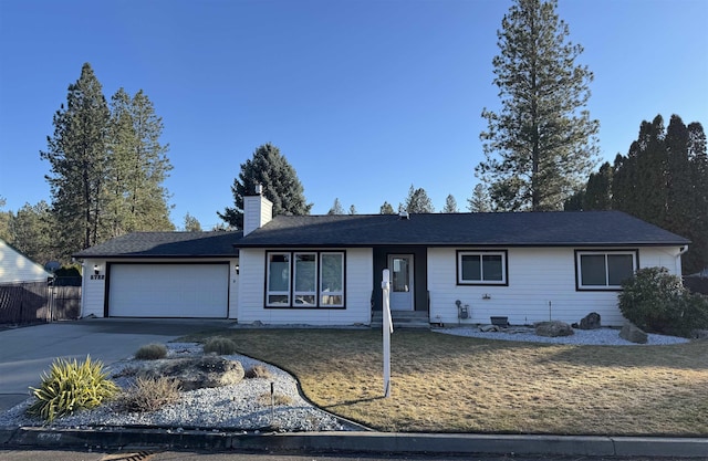 single story home featuring concrete driveway, a chimney, an attached garage, fence, and a front yard