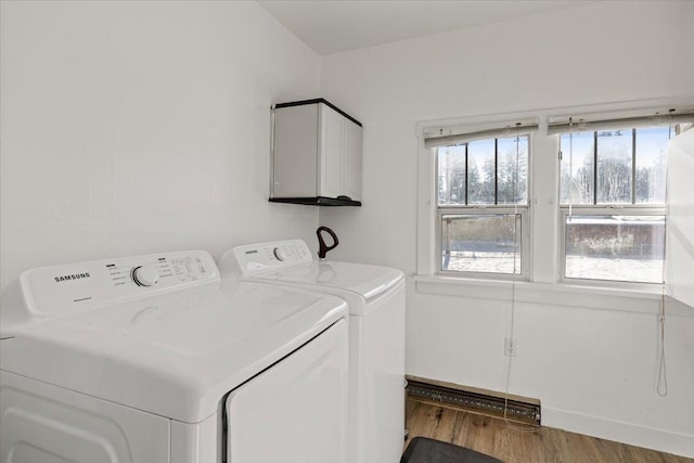 laundry room featuring washer and clothes dryer and light hardwood / wood-style floors