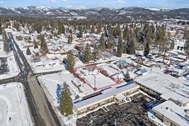 snowy aerial view featuring a mountain view