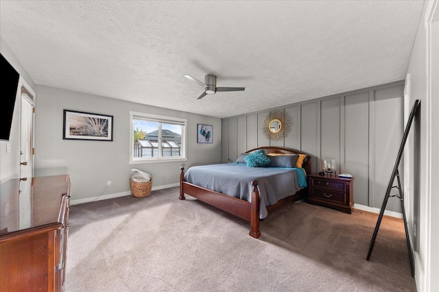 bedroom with light colored carpet, a textured ceiling, and ceiling fan