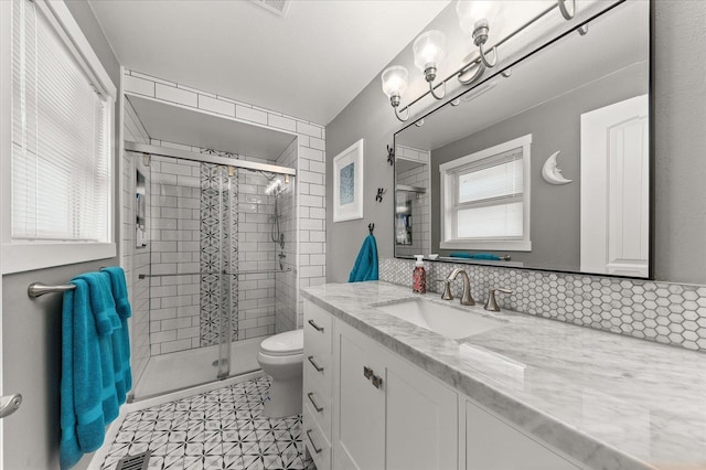 bathroom with vanity, an enclosed shower, and toilet