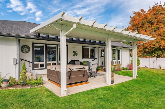 rear view of house featuring a yard, a patio area, and a hot tub