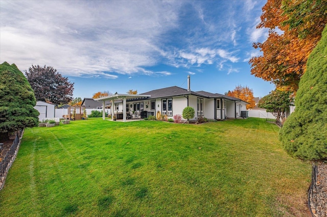 back of house featuring a storage shed, a pergola, and a lawn