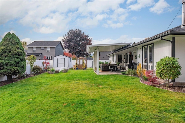 view of yard featuring a patio and a shed