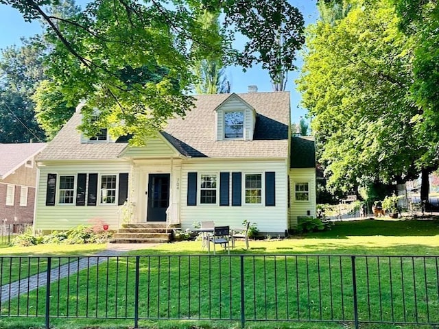 cape cod home with a front lawn