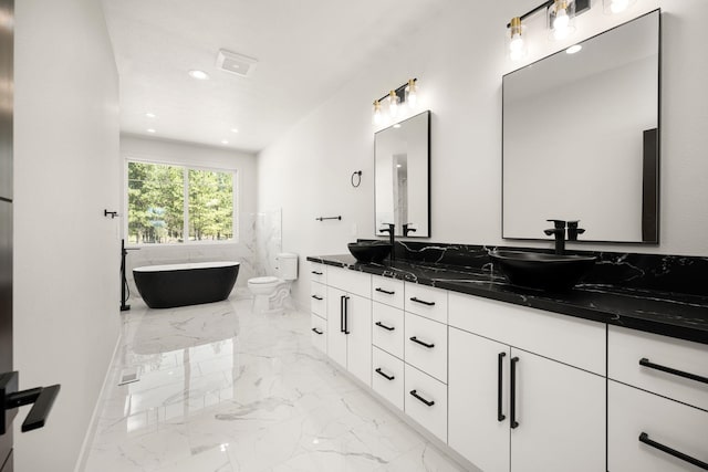 914 E Deer Park-Milan Rd, Deer Park, WA 99006 - full bath featuring marble tiled floors, a soaking tub, double vanity, recessed lighting, and toilet
