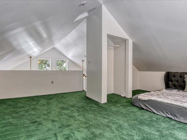 bedroom with carpet and lofted ceiling