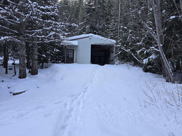 snowy yard featuring an outdoor structure