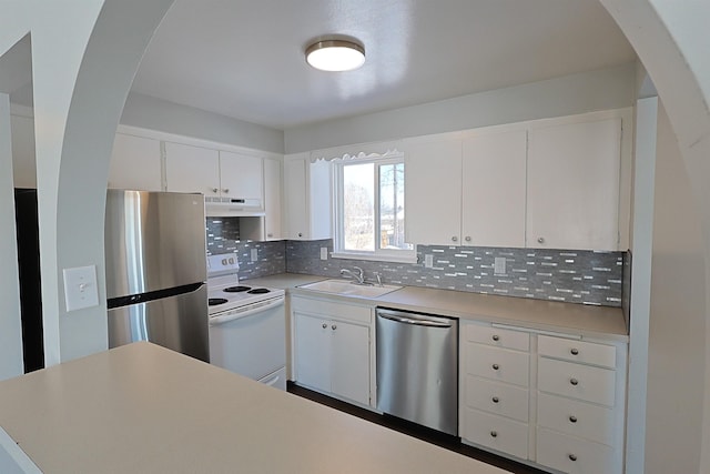 kitchen featuring backsplash, appliances with stainless steel finishes, sink, and white cabinets