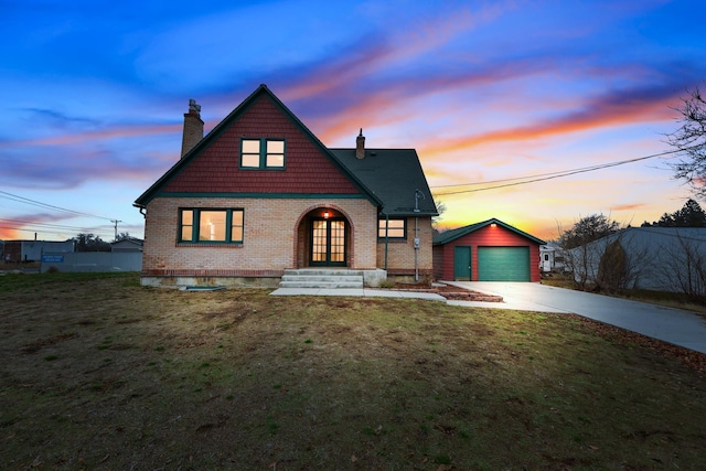 view of front of home with an outbuilding, a garage, and a lawn