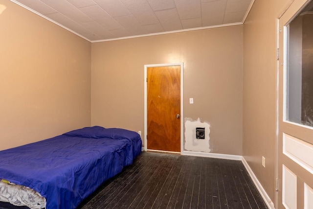 bedroom featuring dark hardwood / wood-style flooring and ornamental molding