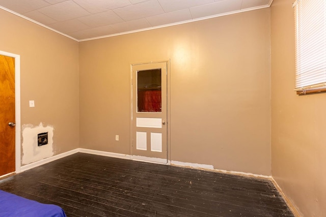 unfurnished room featuring crown molding and dark hardwood / wood-style floors