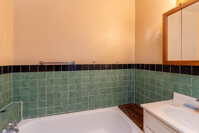 bathroom with vanity, tile walls, and a washtub