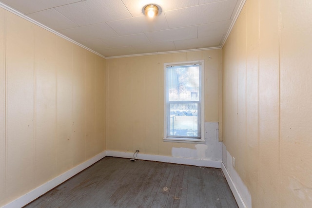 unfurnished room featuring ornamental molding and dark hardwood / wood-style floors