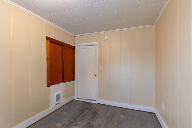 unfurnished room with dark wood-type flooring and ornamental molding