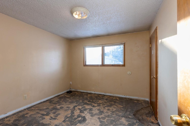 spare room featuring a textured ceiling