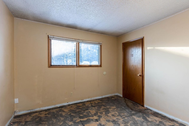 empty room featuring a textured ceiling