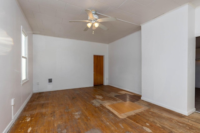 empty room featuring hardwood / wood-style floors, crown molding, and ceiling fan