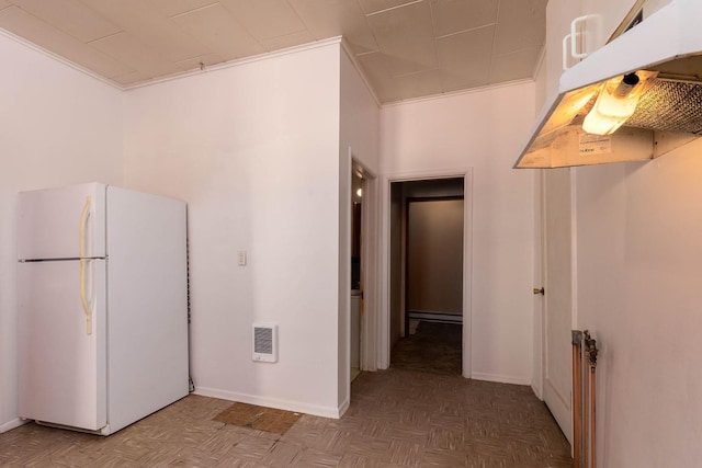 interior space featuring white refrigerator, crown molding, and parquet flooring