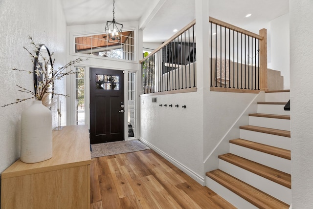 entrance foyer featuring a chandelier and light wood-type flooring