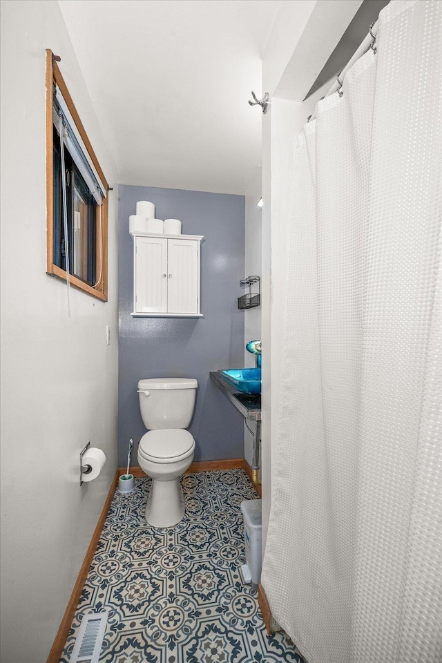 bathroom featuring tile patterned floors and toilet