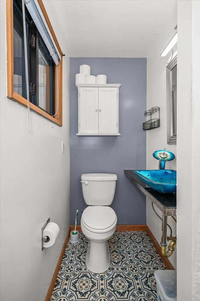 bathroom featuring sink, tile patterned floors, and toilet