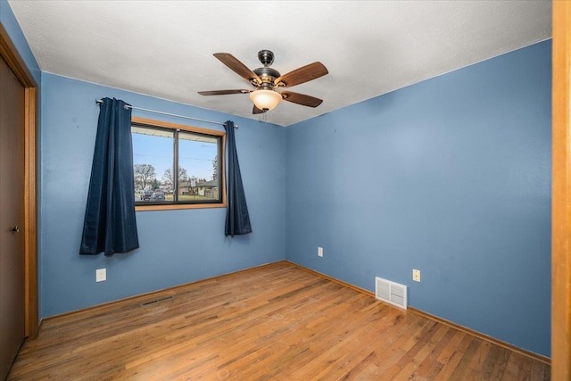 spare room featuring ceiling fan and wood-type flooring