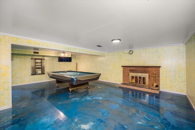 game room featuring billiards, ornamental molding, and a brick fireplace