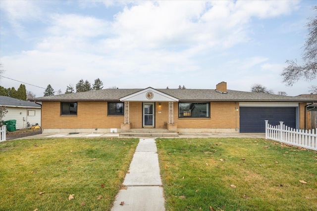 ranch-style home with a garage and a front lawn