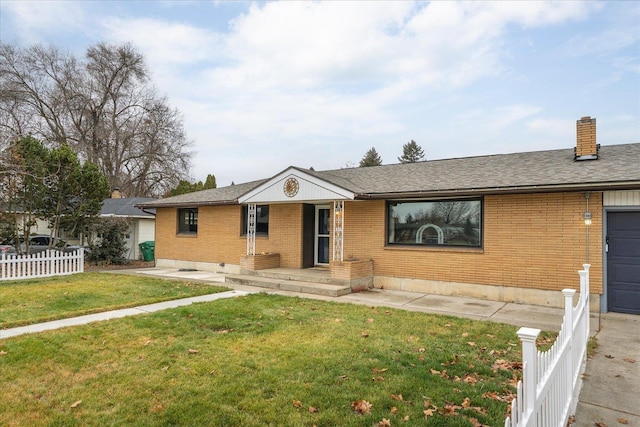 ranch-style home with a garage and a front yard