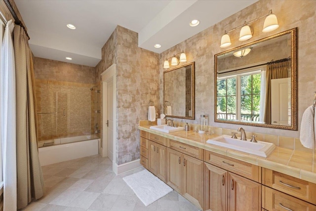 bathroom with vanity and washtub / shower combination