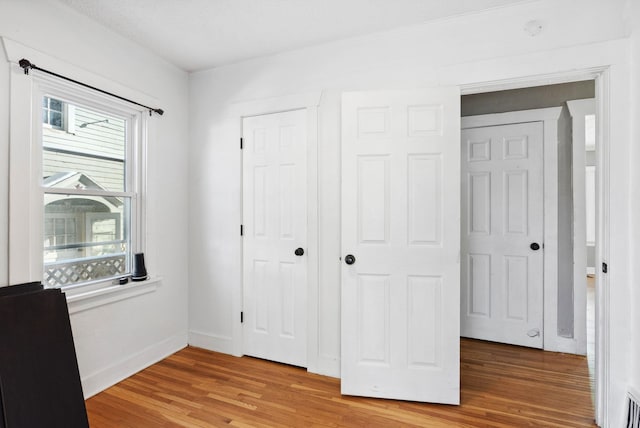 bedroom featuring hardwood / wood-style flooring and a closet