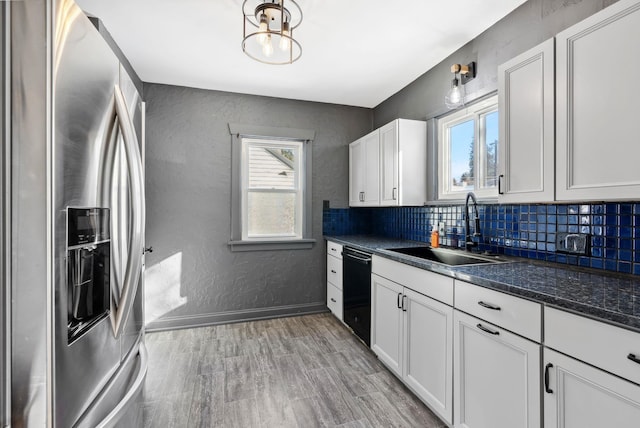 kitchen featuring sink, white cabinetry, black dishwasher, stainless steel refrigerator with ice dispenser, and tasteful backsplash