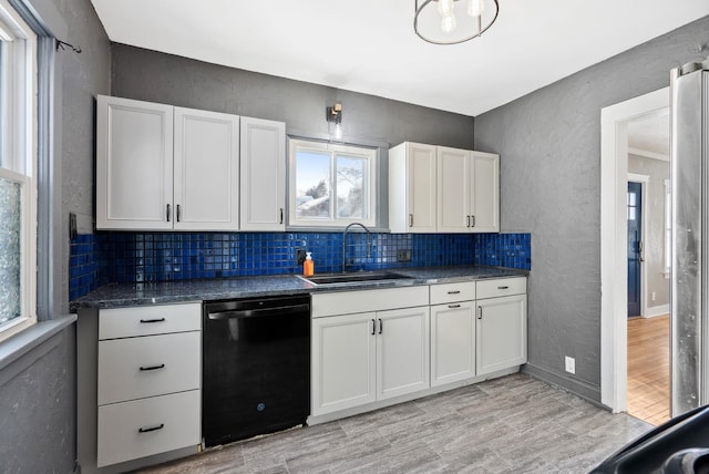 kitchen with white cabinetry, dishwasher, sink, decorative backsplash, and light hardwood / wood-style floors