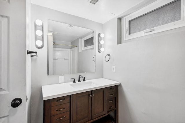 bathroom with vanity and a shower