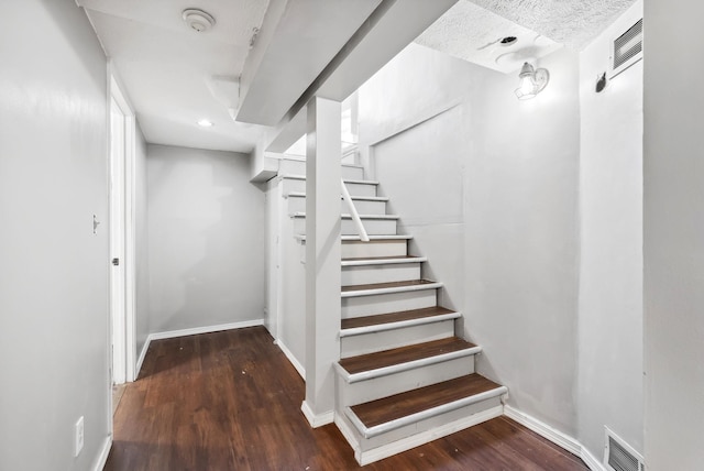 stairway with wood-type flooring