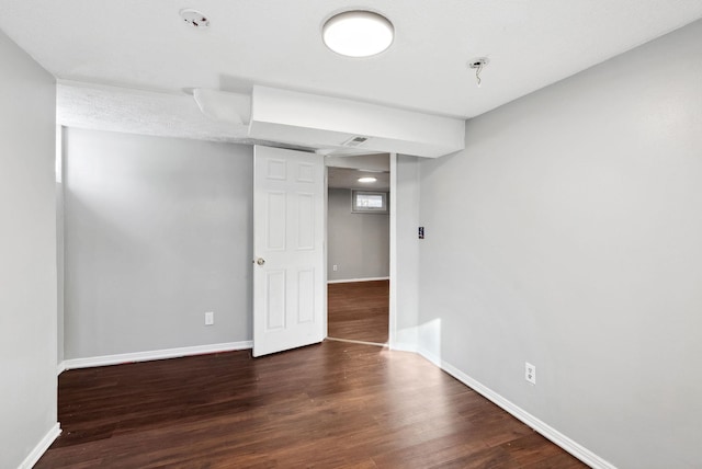 spare room with dark hardwood / wood-style flooring